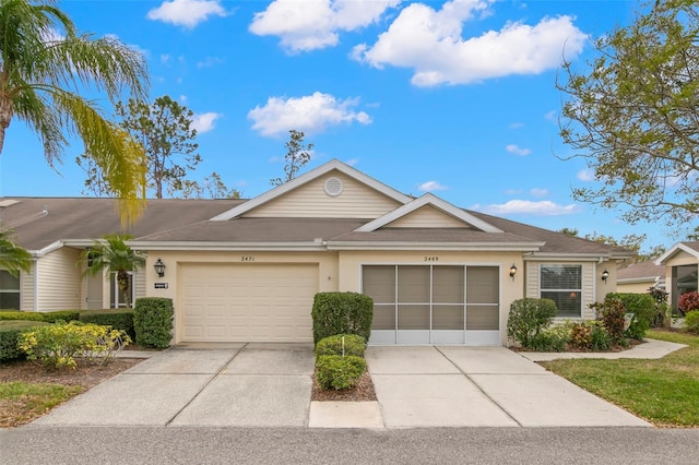 ranch-style home featuring a garage, driveway, and stucco siding