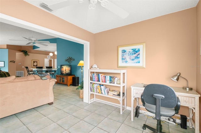 office featuring a ceiling fan, visible vents, baseboards, and light tile patterned floors