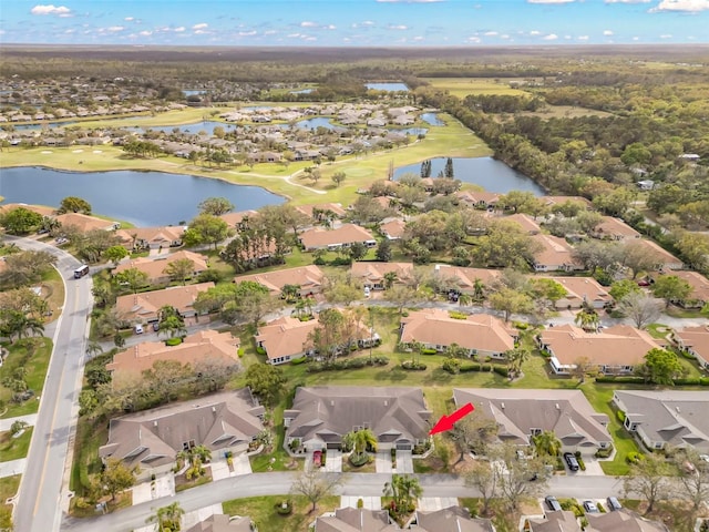 birds eye view of property featuring a water view, view of golf course, and a residential view