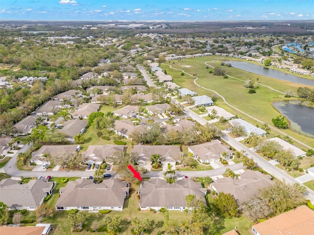 drone / aerial view featuring a residential view and a water view