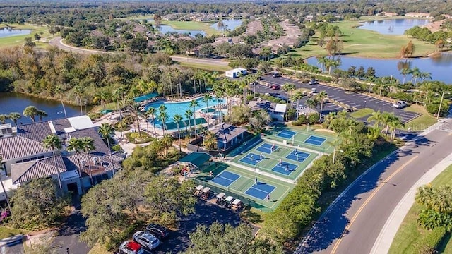 drone / aerial view featuring view of golf course and a water view