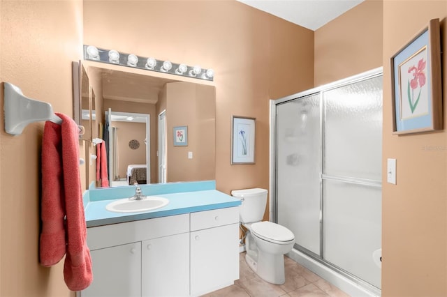 full bathroom featuring toilet, a stall shower, vanity, and tile patterned floors