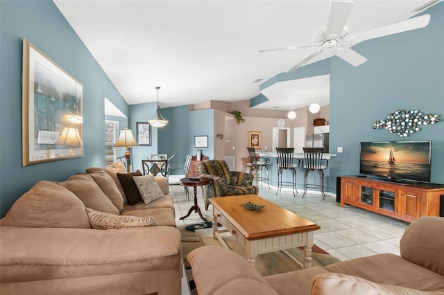 living room featuring vaulted ceiling, a ceiling fan, and light tile patterned flooring