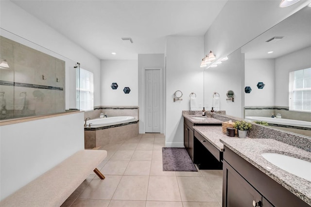 full bathroom with visible vents, two vanities, a sink, tile patterned flooring, and a bath