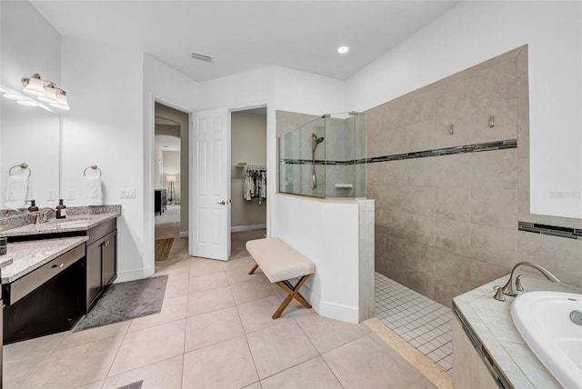 bathroom featuring visible vents, a garden tub, tile patterned flooring, vanity, and a walk in shower