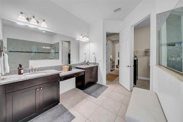 bathroom featuring two vanities, a sink, visible vents, tiled shower, and tile patterned floors