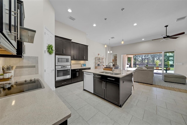 kitchen featuring open floor plan, appliances with stainless steel finishes, a sink, and visible vents