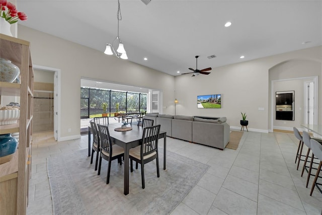 dining space featuring light tile patterned floors, ceiling fan, arched walkways, recessed lighting, and baseboards