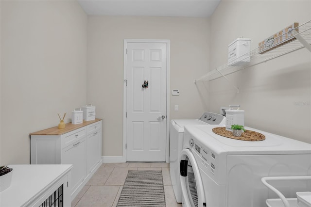 washroom featuring laundry area, independent washer and dryer, and light tile patterned flooring