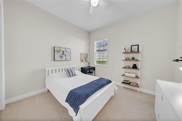 bedroom featuring light colored carpet, ceiling fan, and baseboards