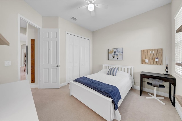 bedroom with a closet, visible vents, light carpet, and multiple windows