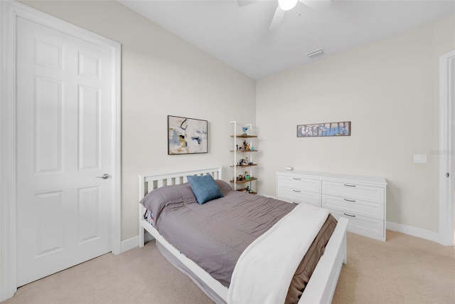 bedroom featuring a ceiling fan, light carpet, visible vents, and baseboards