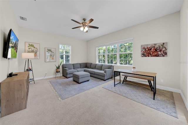 living area with ceiling fan, carpet floors, visible vents, and baseboards