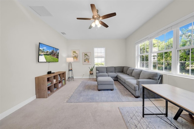 carpeted living room with a ceiling fan, visible vents, and baseboards