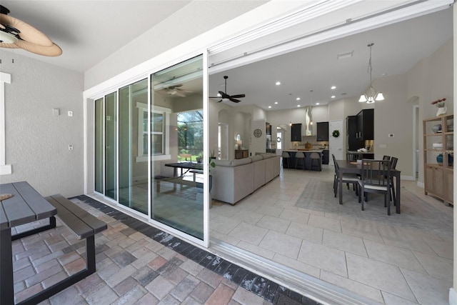 interior space with outdoor dining area and ceiling fan