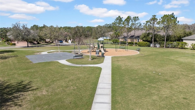 view of community featuring playground community and a yard