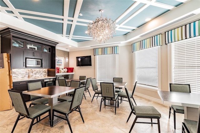 dining room featuring baseboards, a chandelier, coffered ceiling, and beamed ceiling