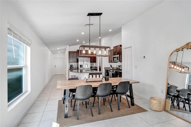 dining room featuring lofted ceiling, light tile patterned flooring, visible vents, and recessed lighting