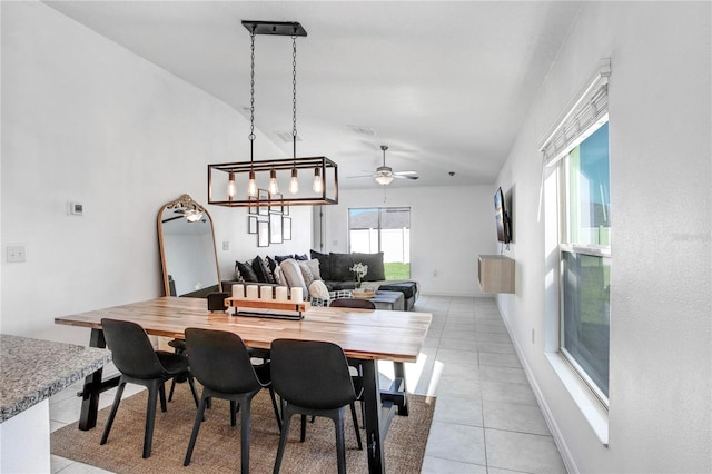 dining space with light tile patterned flooring, ceiling fan, visible vents, and baseboards