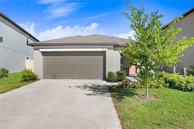 view of front of house featuring a garage, driveway, a front lawn, and stucco siding