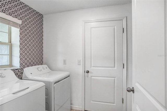 laundry area featuring laundry area, wallpapered walls, and washer and dryer