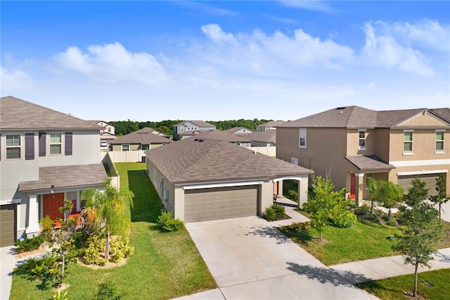 traditional-style home with a garage, concrete driveway, a residential view, a front lawn, and stucco siding