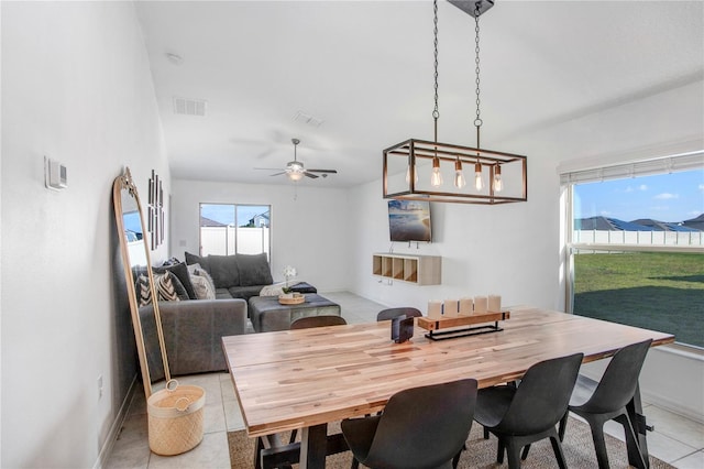 dining area with baseboards, visible vents, ceiling fan, and light tile patterned flooring