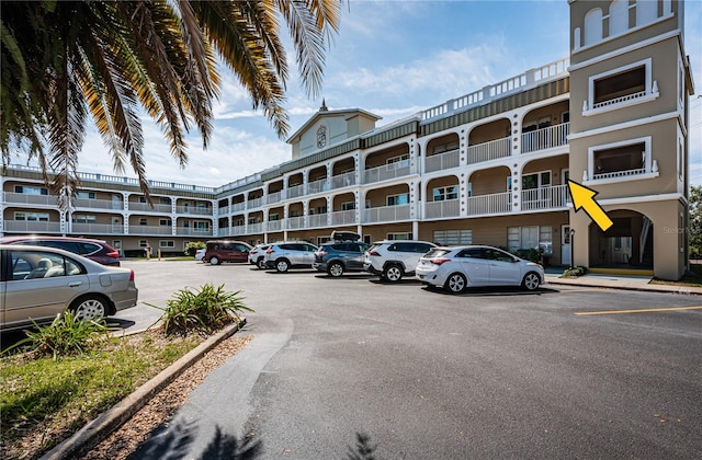 view of building exterior with uncovered parking