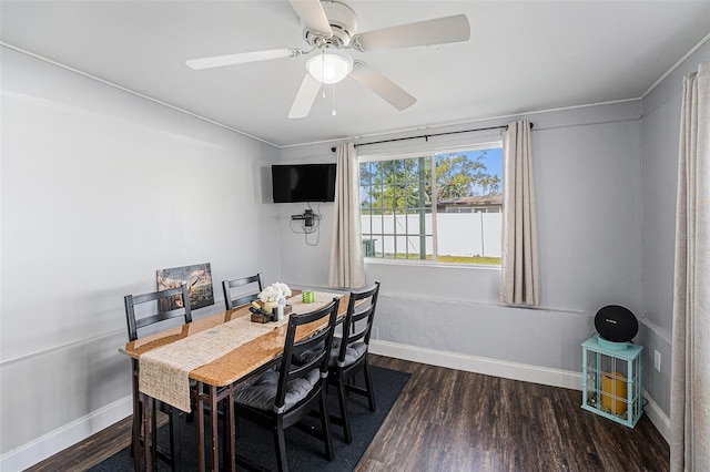 dining area featuring a ceiling fan, baseboards, and wood finished floors