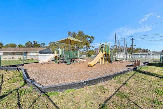 community play area with a yard and fence