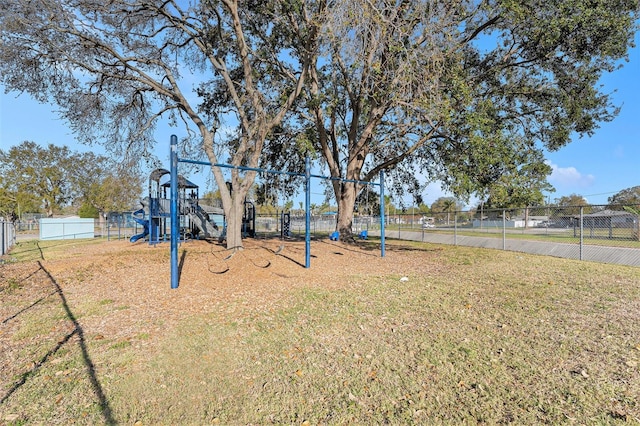 view of yard featuring playground community and fence