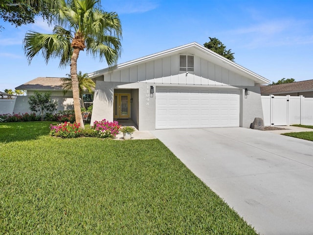 single story home featuring concrete driveway, board and batten siding, a front yard, fence, and a garage