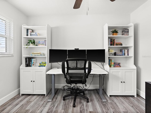 office space with ceiling fan, light wood-style flooring, and baseboards