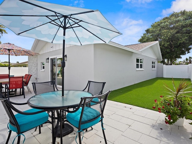 view of patio featuring fence and outdoor dining space