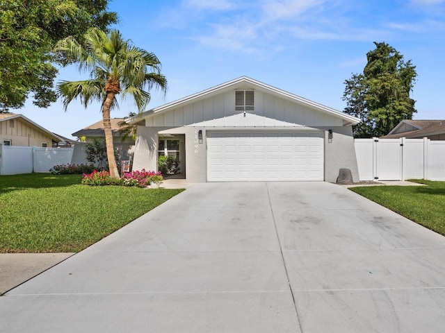 ranch-style house featuring a garage, driveway, fence, and a front yard