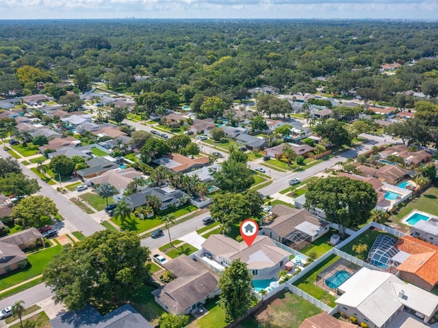 birds eye view of property featuring a residential view and a view of trees