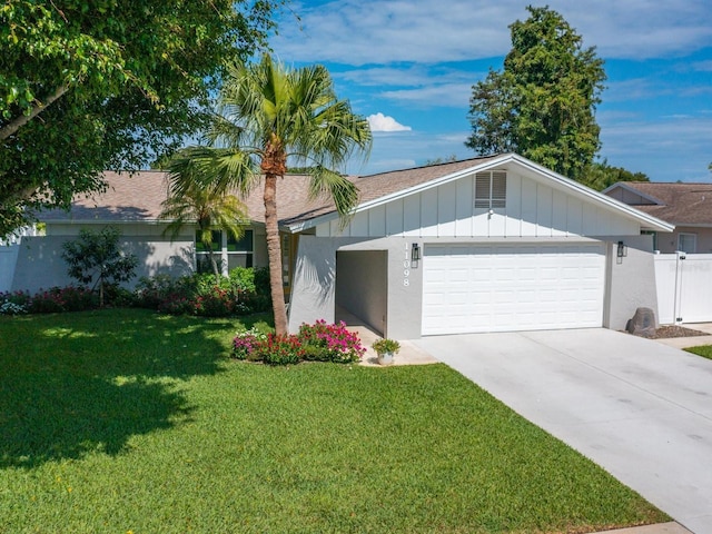 single story home featuring a garage, concrete driveway, fence, a front lawn, and board and batten siding