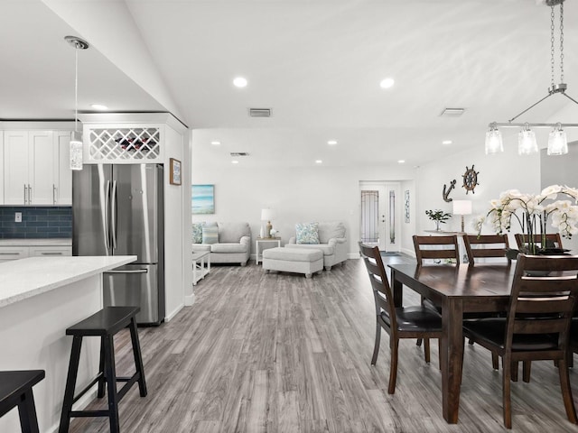 dining room with visible vents, wood finished floors, and recessed lighting