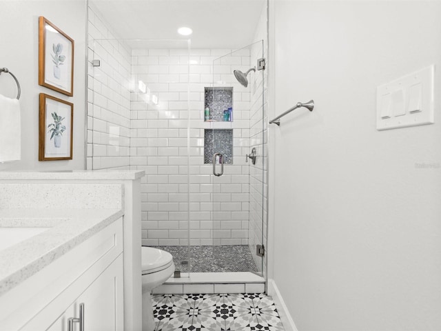 bathroom with a stall shower, baseboards, toilet, tile patterned floors, and vanity