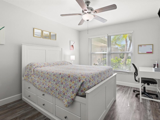 bedroom with a ceiling fan, baseboards, and dark wood-style flooring