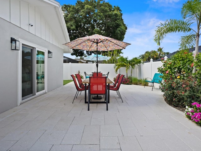 view of patio featuring outdoor dining area and a fenced backyard