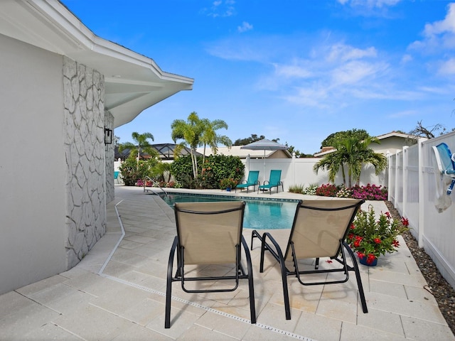 view of swimming pool with a patio area, a fenced backyard, and a fenced in pool