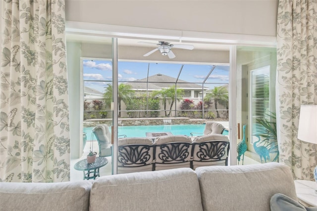 living room with a sunroom and ceiling fan