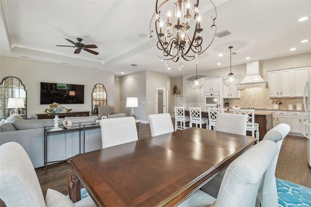 dining area featuring dark wood-style floors, visible vents, a raised ceiling, and recessed lighting