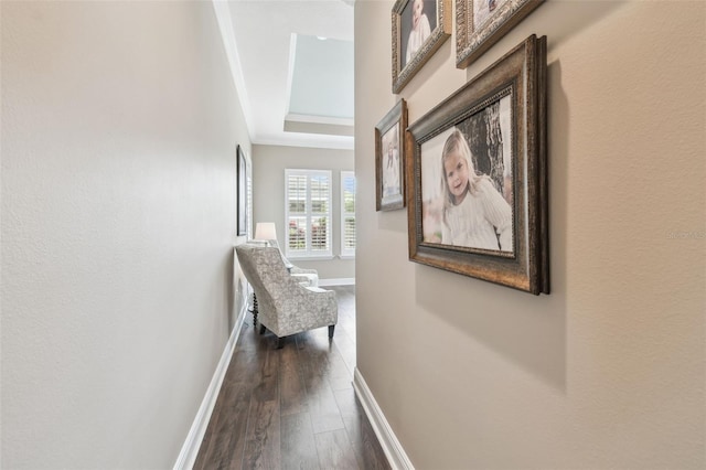 corridor with dark wood-type flooring and baseboards