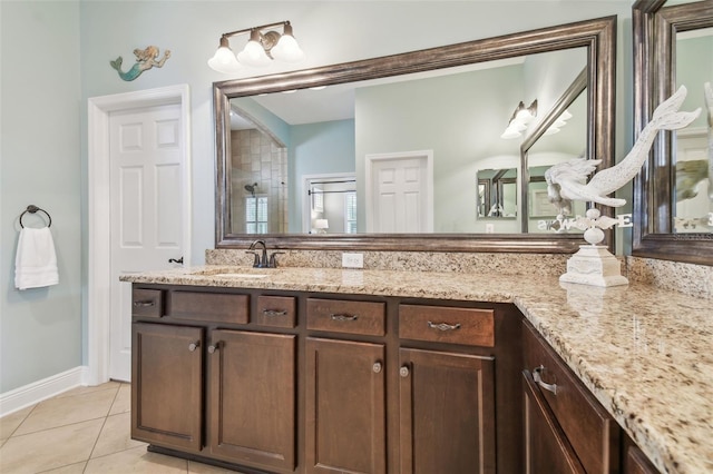 bathroom featuring baseboards, vanity, and tile patterned floors