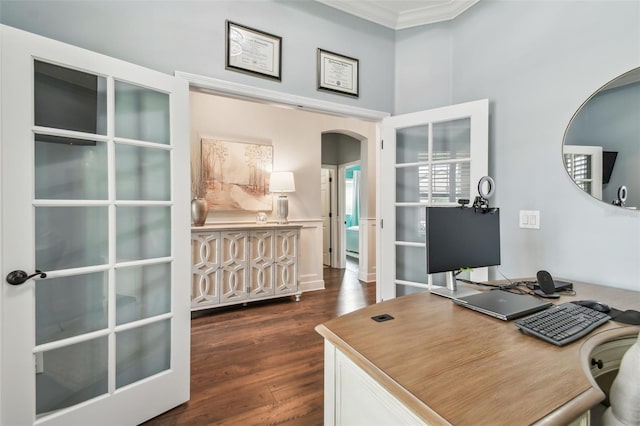 office featuring arched walkways, dark wood-style flooring, and crown molding