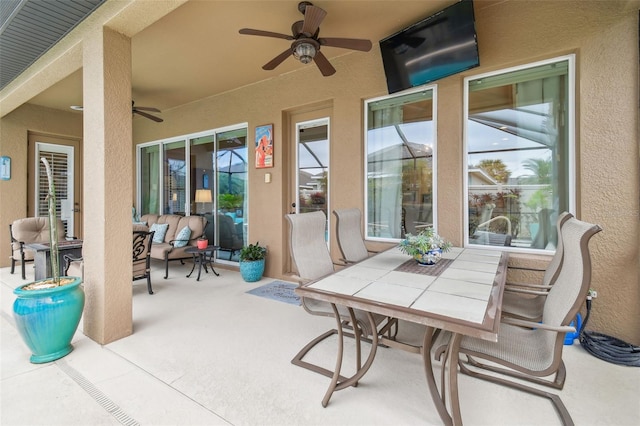 view of patio featuring a ceiling fan, outdoor dining area, and outdoor lounge area