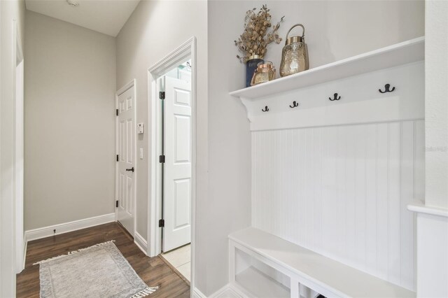 mudroom with baseboards and wood finished floors