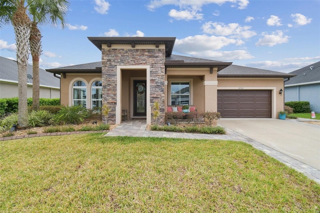 view of front of property featuring driveway, stone siding, an attached garage, a front lawn, and stucco siding